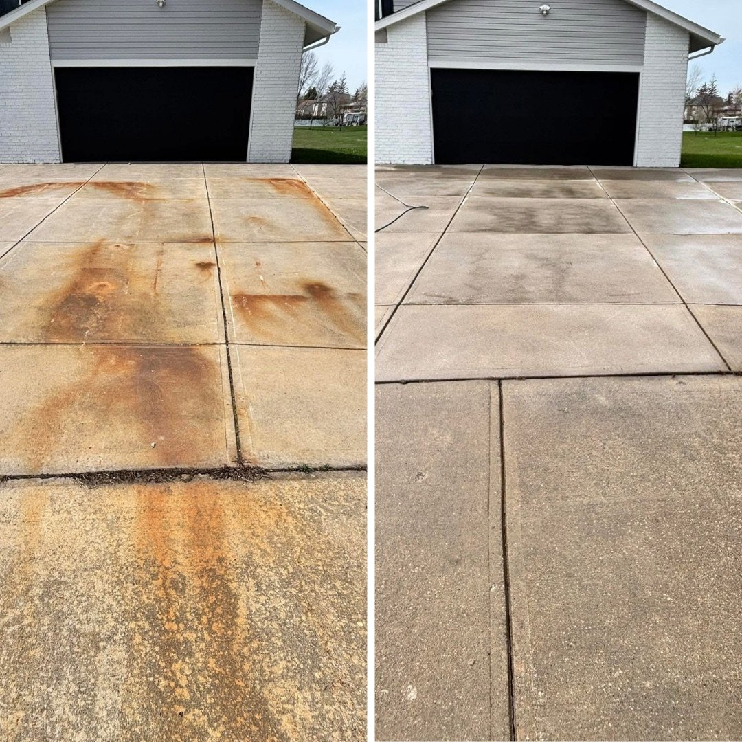 Concrete driveway before and after pressure washing, with heavy rust and iron staining fully removed